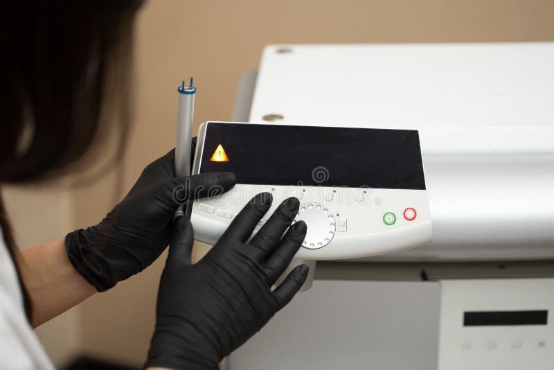 Therapist Beautician Makes A Laser Treatment To Young Woman S Face At Beauty Spa Clinic Close