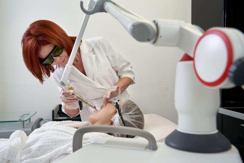 Young Woman Receiving Laser Treatment In Cosmetology Clinic Stock Image Image Of Laser