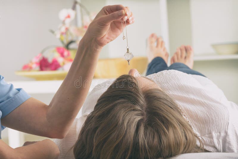 Therapist Using Pendulum To Make a Diagnosis Stock Image Image of