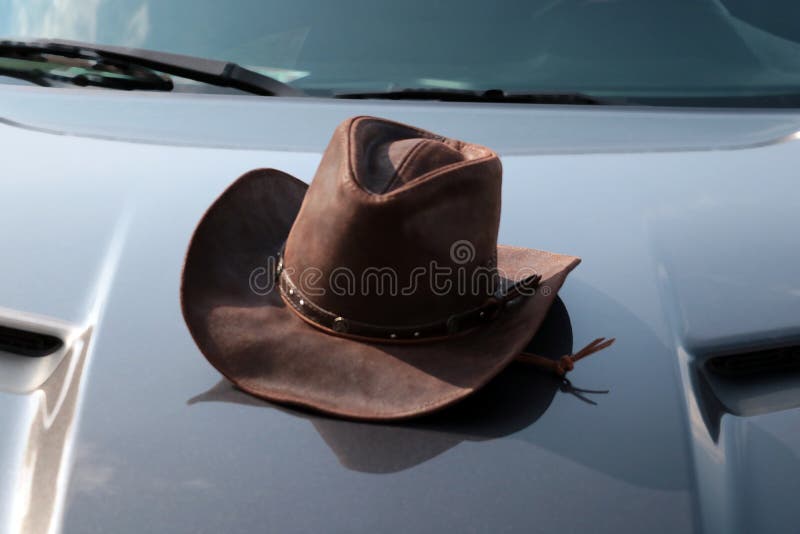 There is a Cowboy Hat on the Hood of the Car. Stock Image Image of