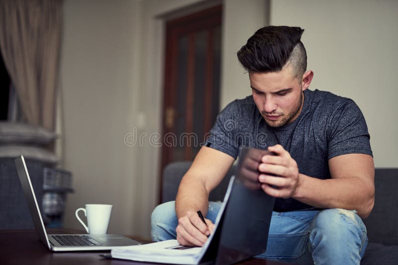 There is no substitute for hard work. a driven young man using his laptop to work from home. royalty free stock photo