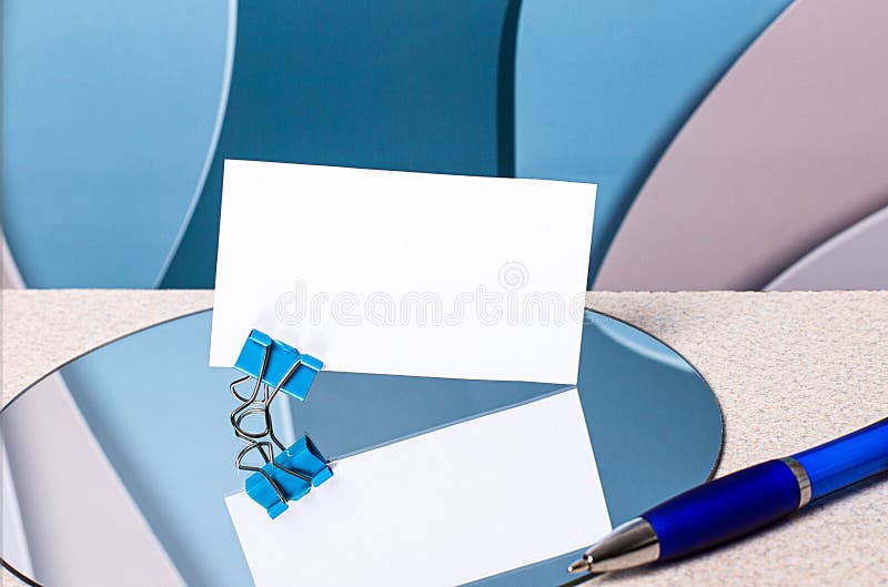 There is a white blank card with a place to insert text on a paper clip on the mirror. Next to the handle. A beautiful background and a card are visible in the reflection. Mockup.