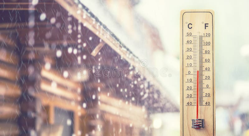 Thermometer displaying 5 degrees celsius or 40 fahrenheit, in the background house and rainy weather. Thermometer displaying 5 degrees celsius or 40 fahrenheit, in the background house and rainy weather.