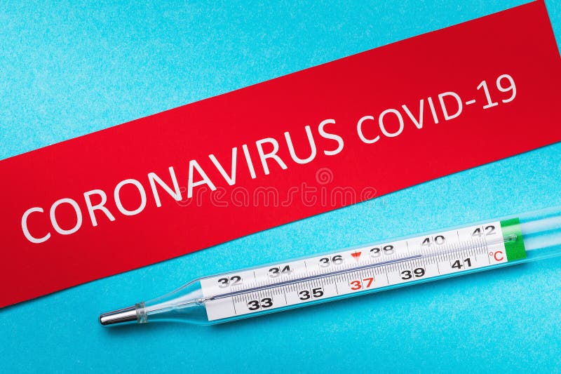 Thermometer and a sheet of paper with the inscription coronavirus. COVID-19 virus prevention concept. Thermometer and a sheet of paper with the inscription coronavirus. COVID-19 virus prevention concept.