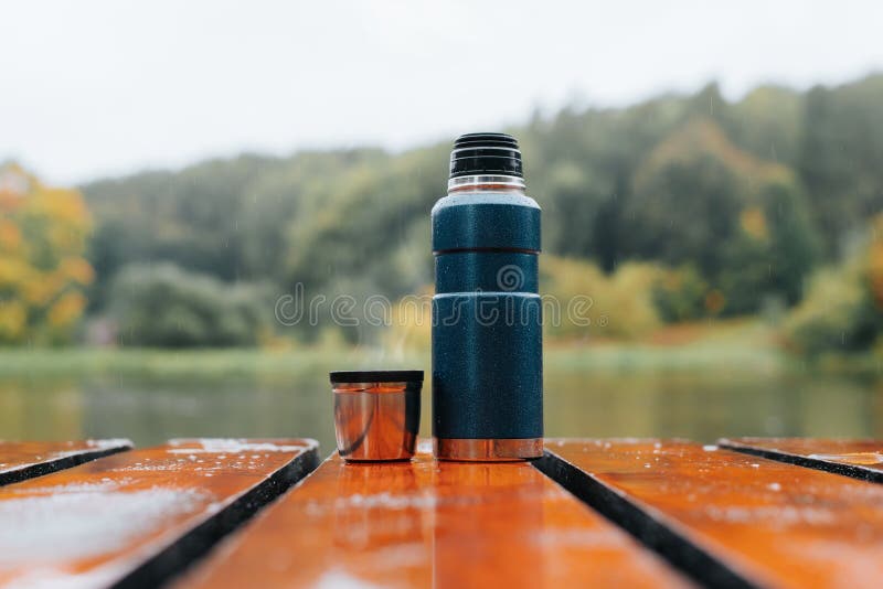 Hike, camping concept. Thermos and aluminum mug hot drink with