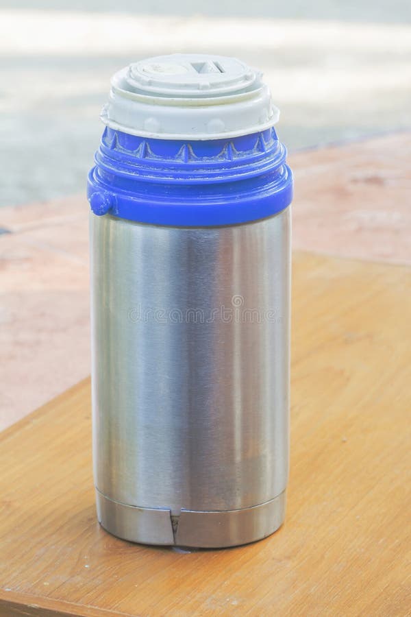 Hike, camping concept. Thermos and aluminum mug hot drink with