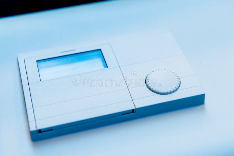 Thermostat closeup detail on blue background royalty free stock images