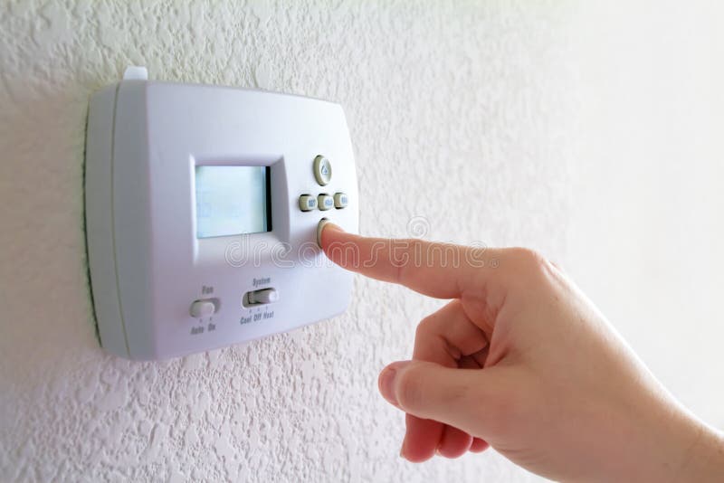 Thermostat et main humaine photo stock Thermostat et main humaine photo stock