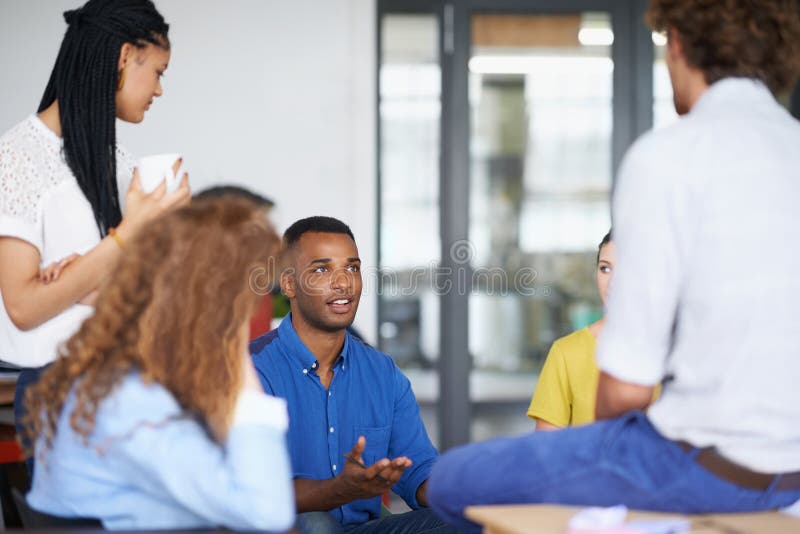 Theyre a strong business group. A group of young coworkers discussing work. royalty free stock photo