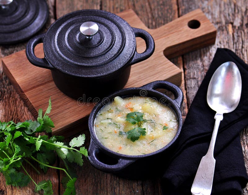 Thick Soup of Corn Grits with Potatoes, Carrots, Garlic, Dill and Coriander Stock Photo Image