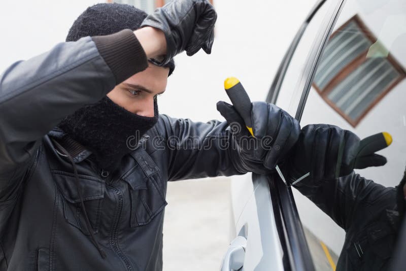 Thief breaking into a car stock image. Image of breaking 49212359