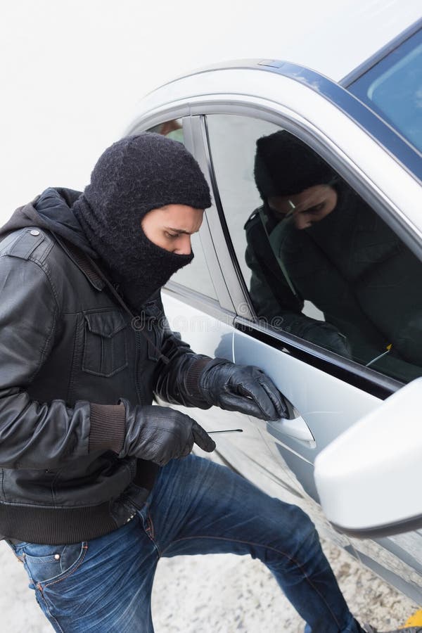 Thief breaking into a car stock photo. Image of social 49212692