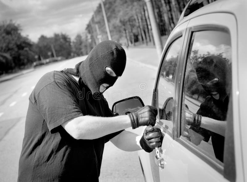 Thief breaks into a car door stock image Thief breaks into a car door stock image