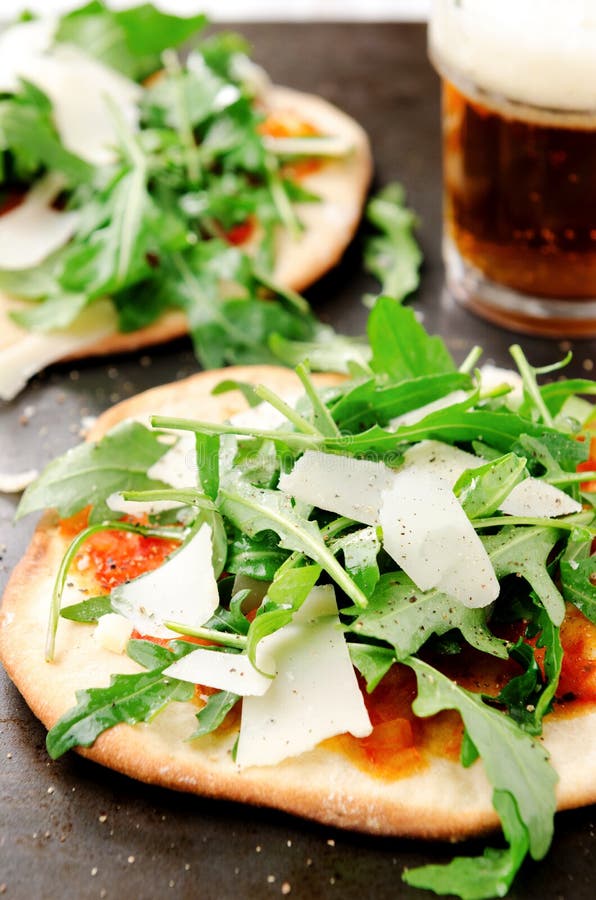 Thin crust individual pizzas with wild rocket stock photos Thin crust individual pizzas with wild rocket stock photos