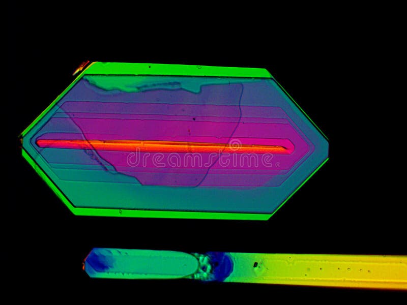 Thin layer of crystals of different chemicals seen in a microscope with polarized light royalty free illustration