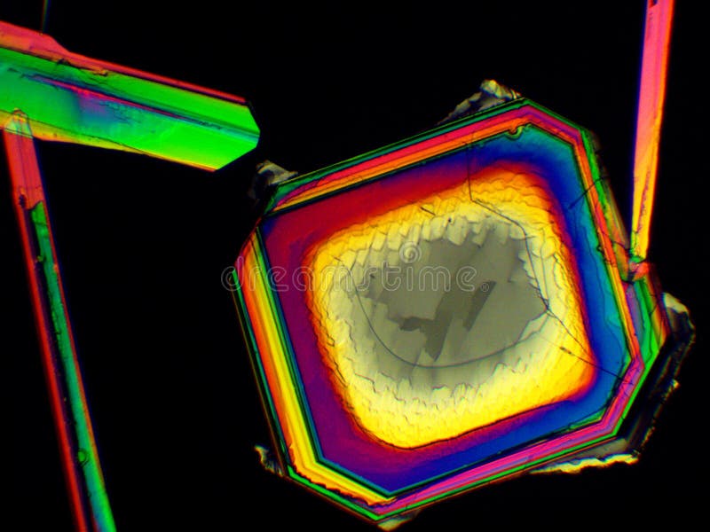 Thin layer of crystals of different chemicals seen in a microscope with polarized light royalty free illustration