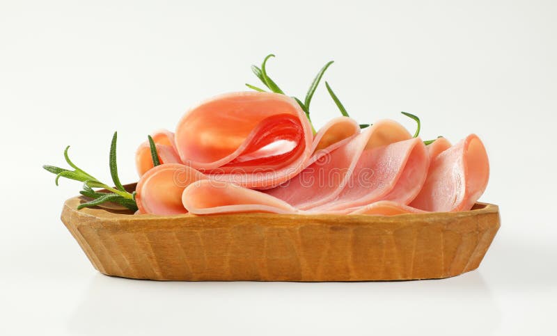 Thin slices of ham with rosemary