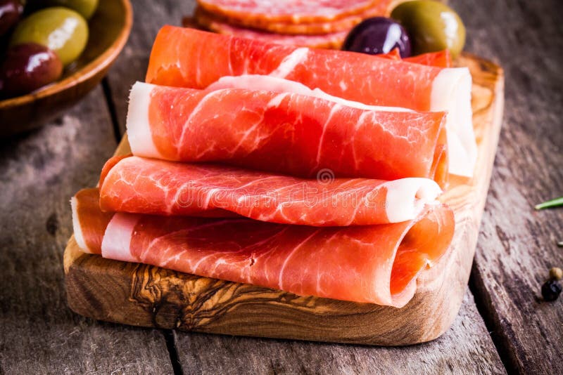 Thin Slices of Prosciutto with Olives on a Cutting Board Stock Image Image of board, food