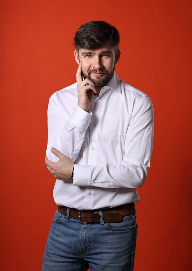 Thinking bearded charismatic man in whirt shirt looking on bright orange background. Closeup portrait royalty free stock images Thinking bearded charismatic man in whirt shirt looking on bright orange background. Closeup portrait royalty free stock images