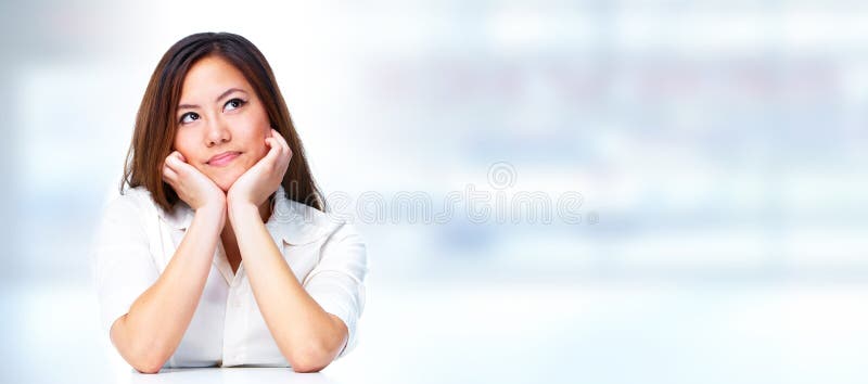 Young asian thinking business woman over blue background. Young asian thinking business woman over blue background.