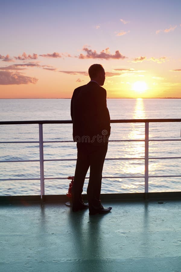 Thinking businessman and red sunset on a ferry