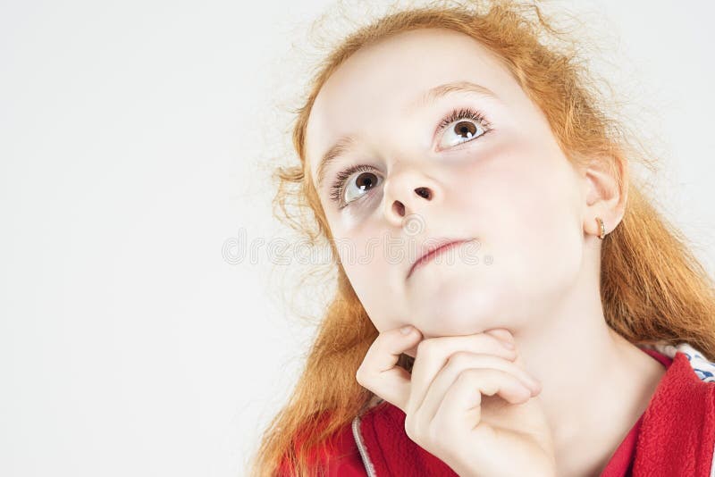 Thinking Red-haired Girl Looking Up and Touching Chin