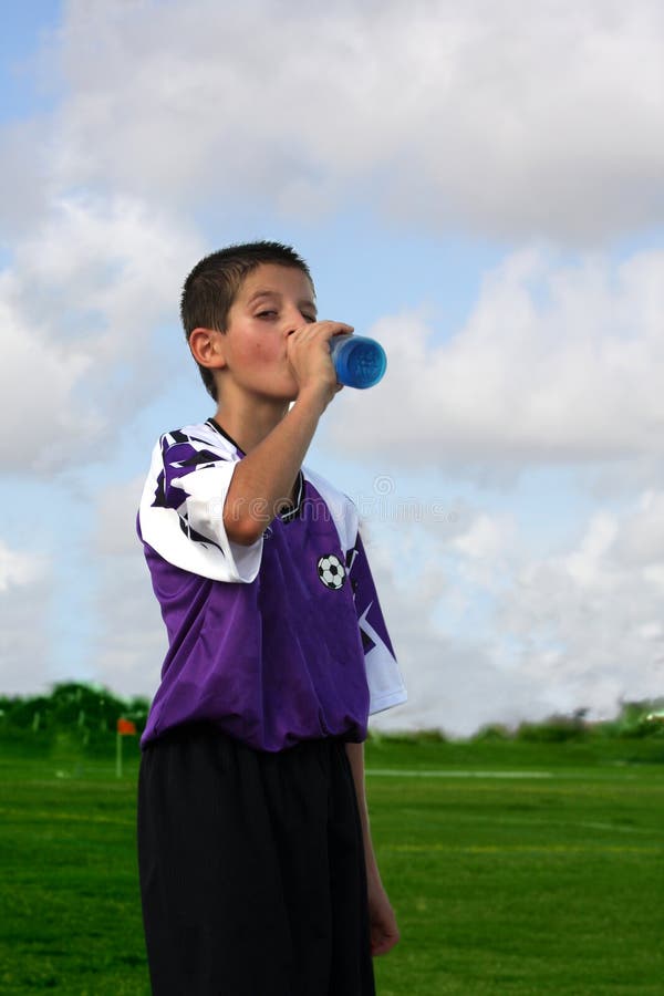 Thirsty boy drinking refreshing drink