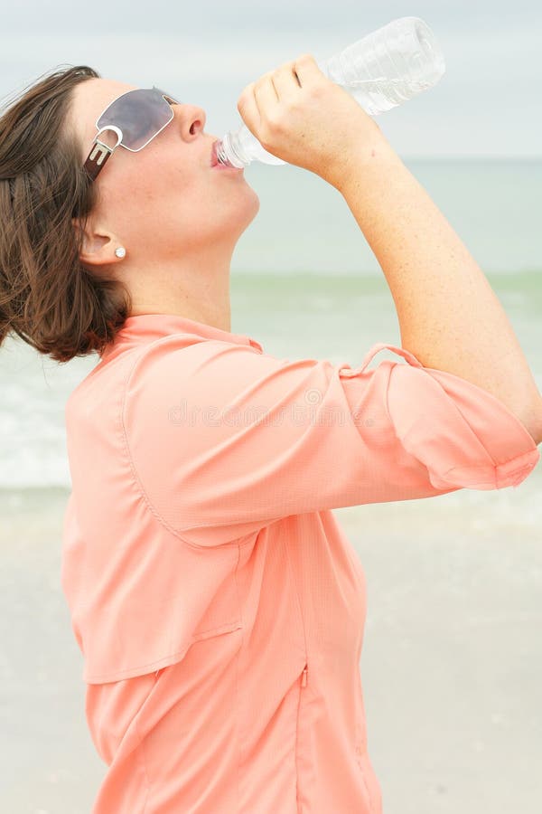 Thirsty brunette at the beach