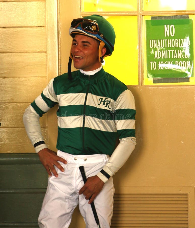 Thoroughbred Jockey Joel Rosario. ARCADIA, CA - FEB 16: Thoroughbred jockey Joel Rosario waits for his first mount, Crucero, in the paddock at historic Santa stock photo Thoroughbred Jockey Joel Rosario. ARCADIA, CA - FEB 16: Thoroughbred jockey Joel Rosario waits for his first mount, Crucero, in the paddock at historic Santa stock photo