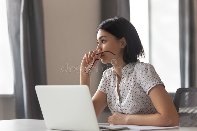 Thoughtful anxious asian business woman looking away thinking solving problem