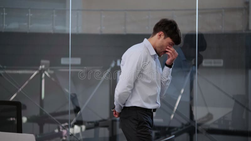 Thoughtful Businessman Pacing Near the Window in the Office stock video