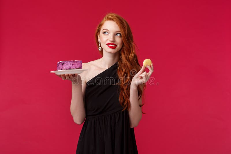 Thoughtful And Dreamy Gorgeous Slim Redhead Woman In Black Dress Thinking About Eating Dessert