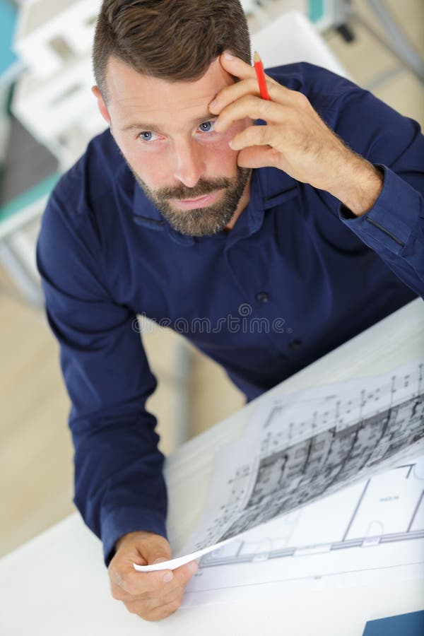 Thoughtful engineer or interior designer stock photos