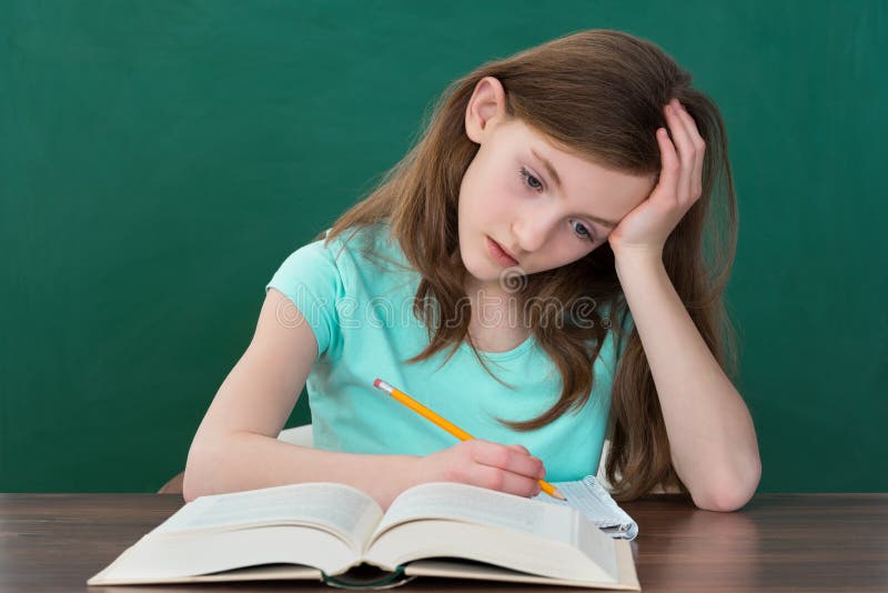 Thoughtful Girl Reading Books royalty free stock images