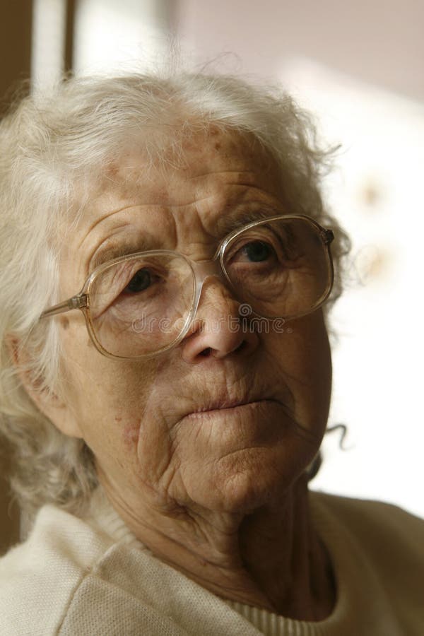 Thoughtful old lady with silver gray hair