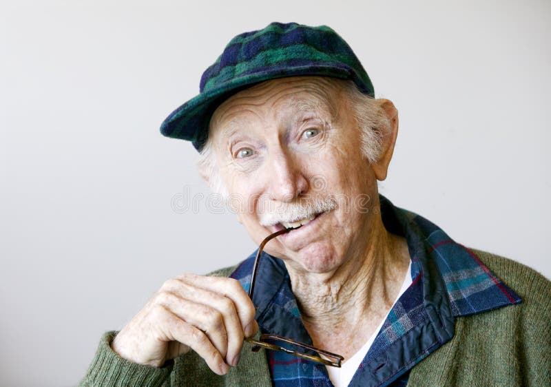 Thoughtful Senior Man in a Hat and Glasses