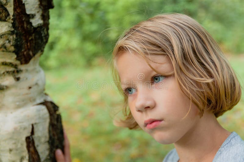 A thoughtful seven-year-old girl stock image