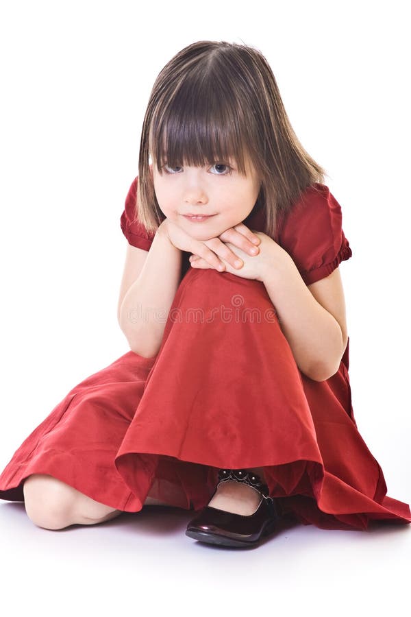 Thoughtful small girl in red dress