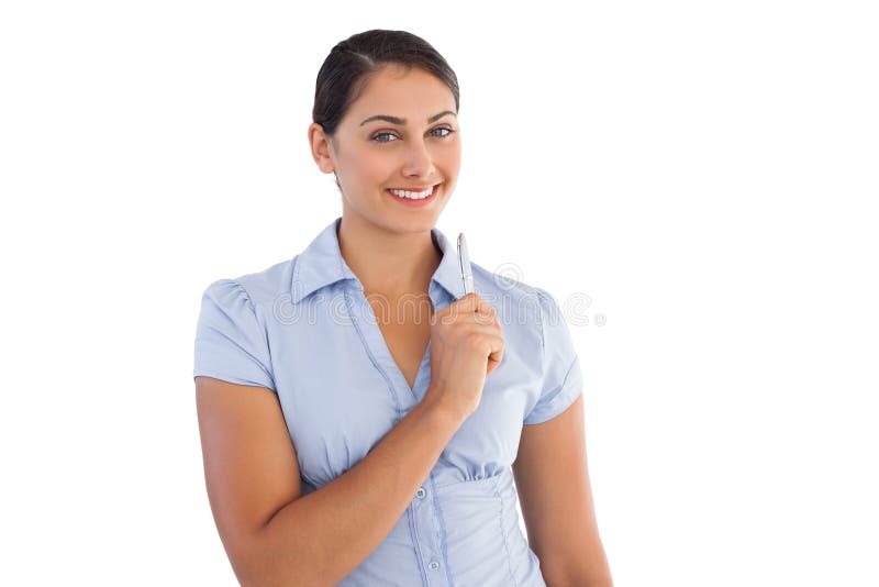 Thoughtful smiling businesswoman holding a pen