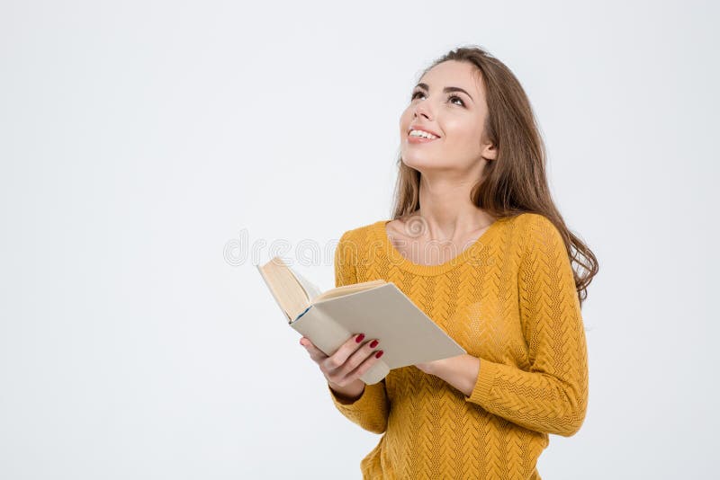 Portrait of a thoughtful woman holding book and looking up at copyspace isolated on a white background