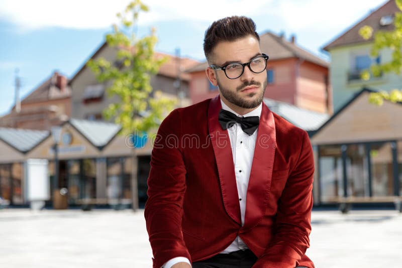 Thoughtful young man wearing red velvet tuxedo and thinking royalty free stock photos Thoughtful young man wearing red velvet tuxedo and thinking royalty free stock photos