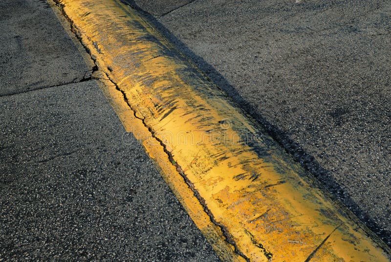 A Beautiful Yellow Speed Bump Jutting Across The Parking Lot Stock