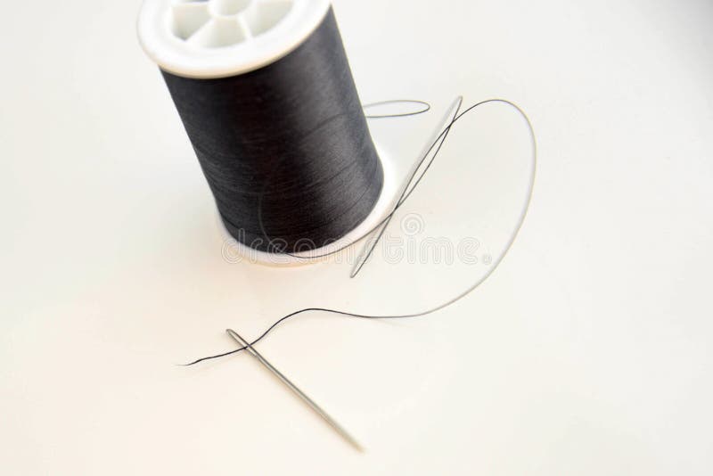 Threaded Needle and Black Spool of Thread Stock Photo Image of