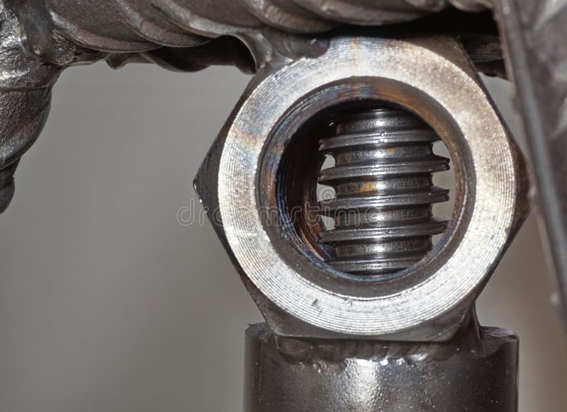 Threaded Steel Rod Behind a Nut Welded To a Steel Structure Stock Photo