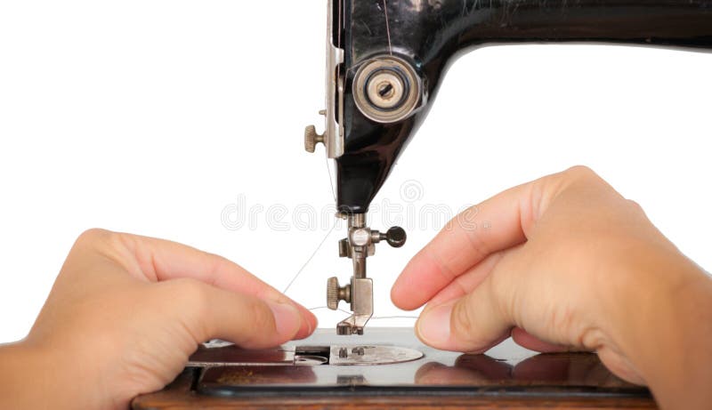 Threading a vintage sewing machine. Two hands threading the needle of an old sewing machine, isolated on white royalty free stock photography Threading a vintage sewing machine. Two hands threading the needle of an old sewing machine, isolated on white royalty free stock photography