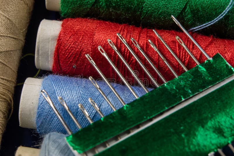 Threads and Needle on the Table in a Tailor& X27;s Closeup