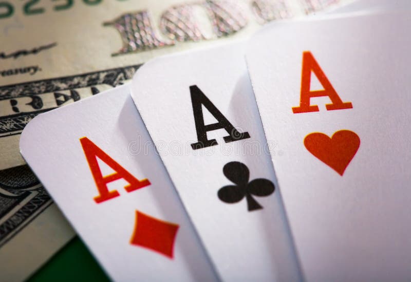 Closeup of three playing cards aces and one hundred dollar bills. Closeup of three playing cards aces and one hundred dollar bills.