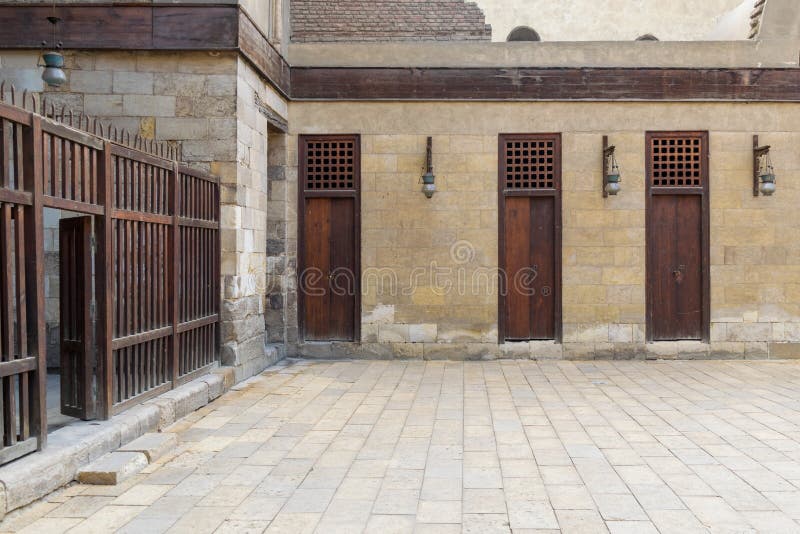 Three adjacent doors in a stone bricks wall and wooden fence, Sultan Al Nassir Qalawun Mosque royalty free stock photos Three adjacent doors in a stone bricks wall and wooden fence, Sultan Al Nassir Qalawun Mosque royalty free stock photos
