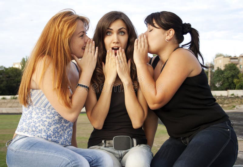 Three adult girls having a conversation
