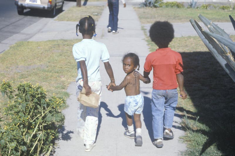 Three African-American children walking home,South Central,Los Angeles, CA